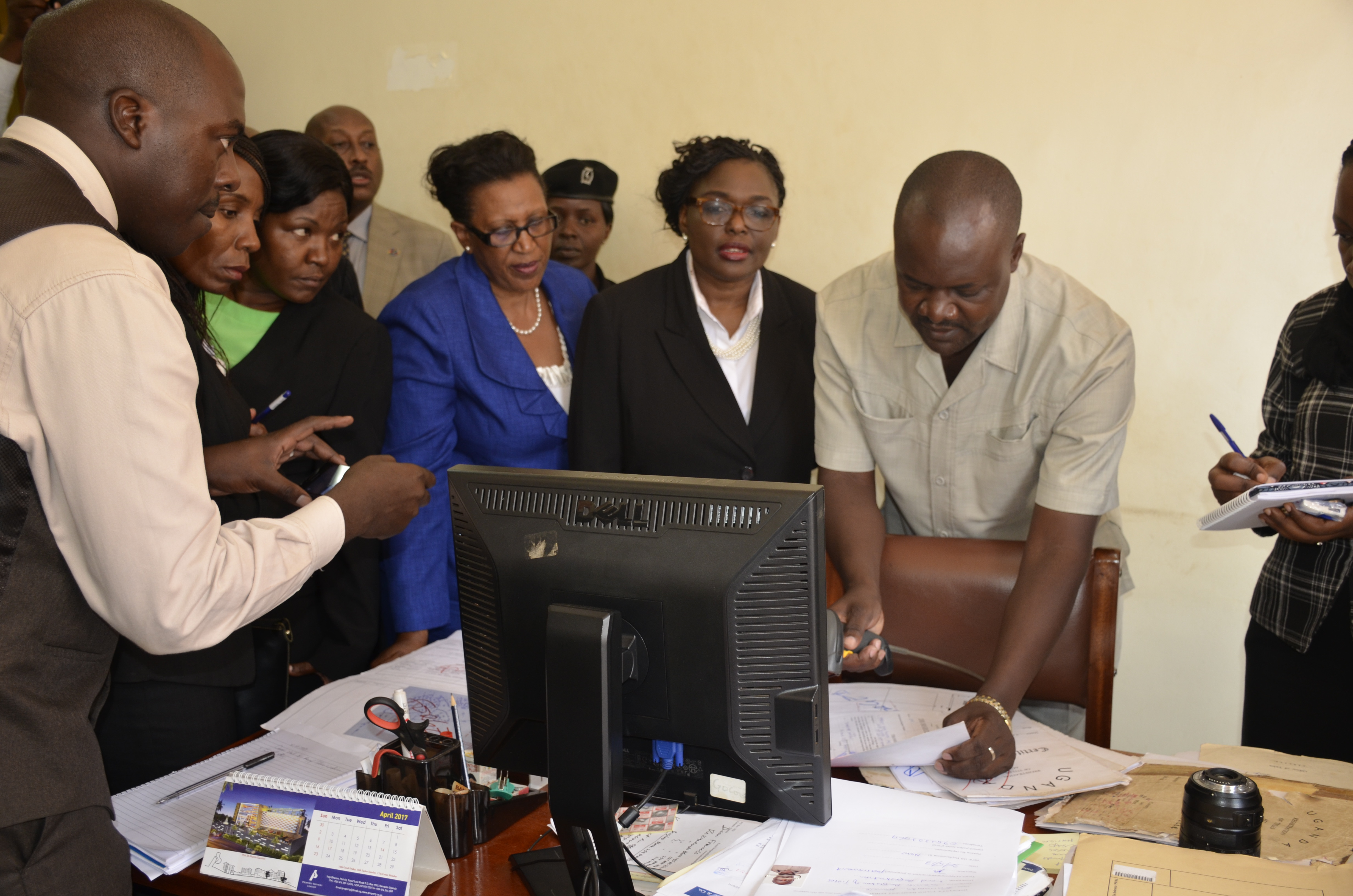 The Registrar of Titles at the Wakiso MZO showing the Commission of inquiry into land matters how to tell a fake title.